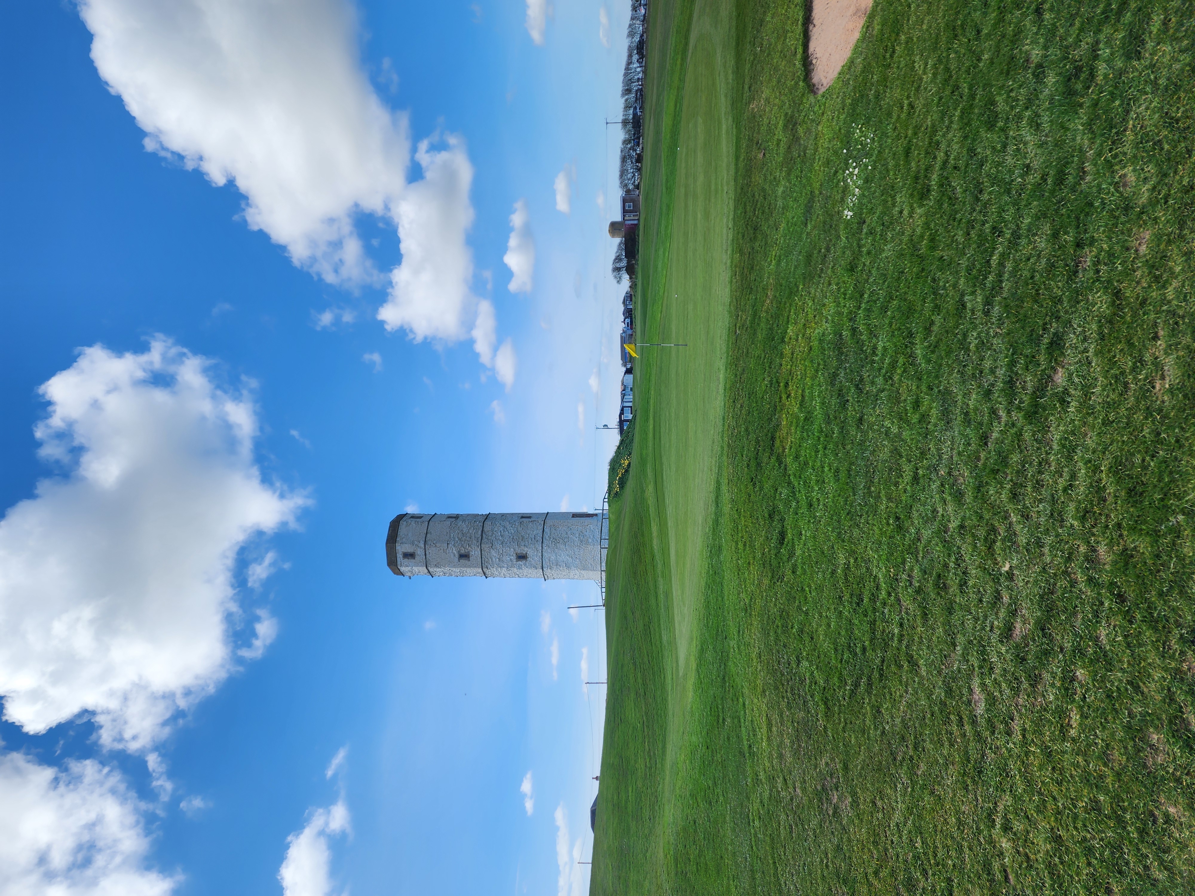 A golfer playing towards a green